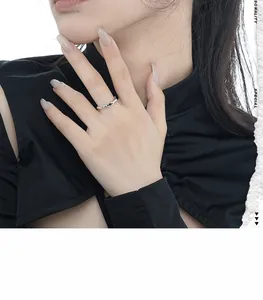 Detail view of S925 sterling silver irregular wavy ring with black enamel drop detail