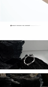 Macro detail of S925 sterling silver ring with irregular texture on dark charcoal