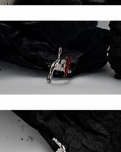 Macro detail of irregular S925 silver ring with red enamel and artistic fluid design