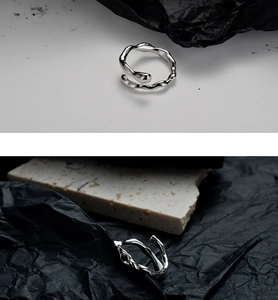 Detail of S925 sterling silver open ring featuring an irregular textured wave design