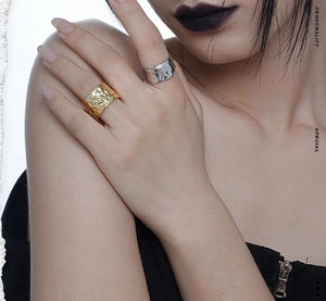 Detail view of gold and silver hammered texture rings with minimalist wide band design