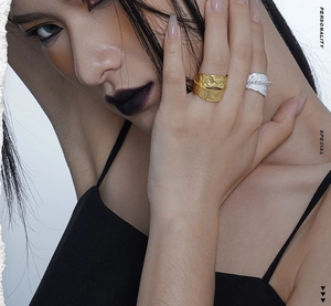 Detail of gold and silver textured irregular S925 sterling silver rings on model hand