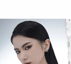 Close-up of a silver knot-shaped ear cuff on a model showing the woven chain design