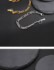 Vue détaillée des bracelets Figaro dorés et argentés avec fermoir mousqueton et pendentif