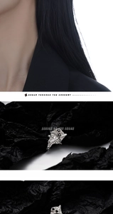 Close-up of irregular silver zircon ring with fluid lava texture on black background