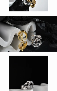 Detailed view of irregular intertwined gold and silver rings on elegant wavy display