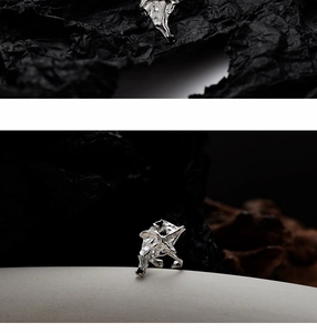 Close-up of molten texture silver ring with black zircon stone on a dark background