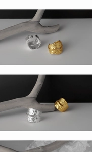Detail of wide open rings in gold and silver with irregular water-ripple textures