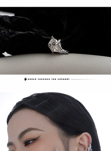 Detail of silver textured ear cuff with black zircon and model wearing on the upper ear