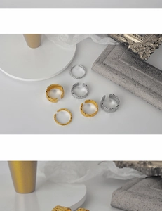 Close-up of textured 925 sterling silver rings in gold and silver with irregular hammered patterns