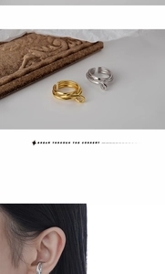 Detail of layered wrap ear cuff in gold and silver finish showing textured design