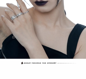 Close-up of three textured 925 silver rings with hammered foil finish on female hand