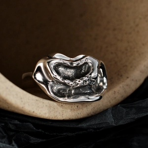 Vintage irregular streamlined silver ring with textured molten lava organic aesthetic