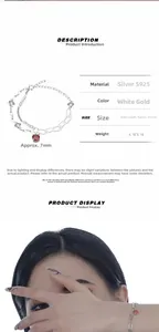 Detail view of S925 silver bracelet with red gemstone and double layer chain design