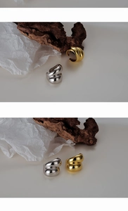 Close-up of modern s925 silver and gold plated intertwined knot rings with high polish