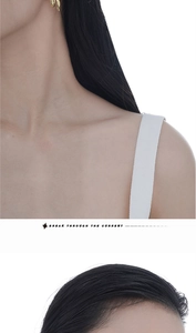 Detail of elegant gold asymmetrical twisted line stud earrings worn by a female model