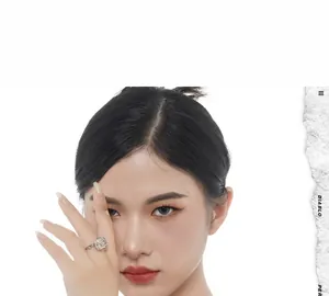 Close-up of a silver floral ring with a pearl center worn by a fashion model on white