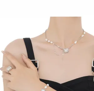 Close-up of baroque pearl jewelry set with artistic silver branch textures and tassels