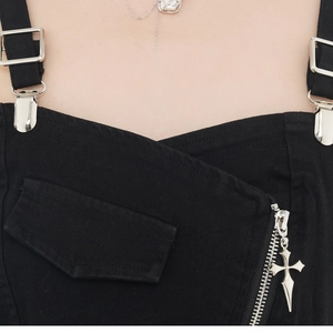 Detailed shot of black twill top with gothic silver cross pendant on metal zipper