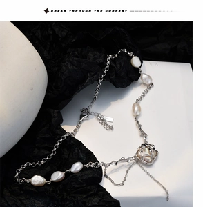 Close-up of S925 sterling silver chain with a large baroque pearl on a geometric stand
