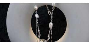 Detailed close-up of square baroque pearls and silver coral accents on a S925 silver necklace