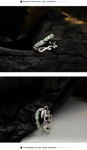 Macro shot of bamboo texture silver ring with green jade beads on black background