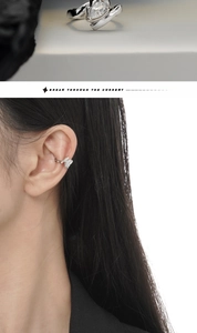 Detailed view and ear model display of a silver teardrop zircon ear cuff with textured metal