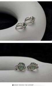 Macro detail of twisted silver band with an oval green aventurine stone and vintage texture