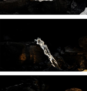 Detail of silver S925 hair pin with liquid metal texture and round opal stone