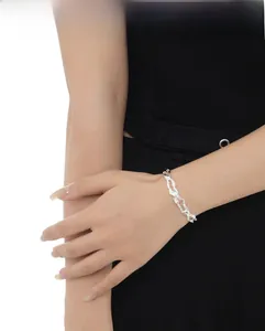 Irregular lava texture sterling silver bracelet on model with black clothing