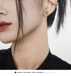 Detailed view of silver ear cuff set with green aventurine stone on female model