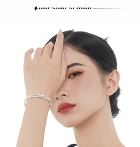 Detail of silver S925 sterling silver cuff with irregular textured melt design on wrist