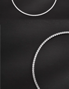 Detailed close-up of a silver tennis necklace with sparkling row of round-cut crystals