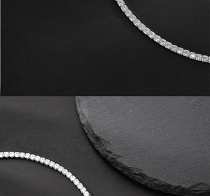 Macro detail of S925 sterling silver tennis chain with four-claw set cubic zirconia stones