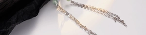 Detail of S925 sterling silver chain tassel and green aventurine bead on the earring