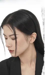 Close-up of vintage silver S925 distressed ear cuff worn on ear cartilage for unisex style