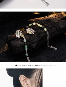 Macro view of silver tassel earrings with green aventurine jade and detachable chain