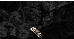 Macro shot of S925 silver earring with vintage distressed texture and gold accents