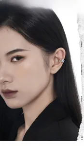 Detailed view of square blue zircon ear cuff with silver thorn texture on a model