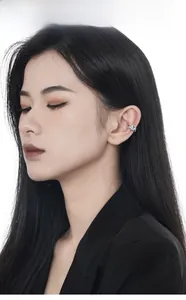 Detail of S925 silver ear cuff with square blue zircon on model's ear in minimalist style