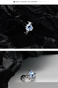 Macro detail of square blue zircon stone with silver thorn texture cuff earring