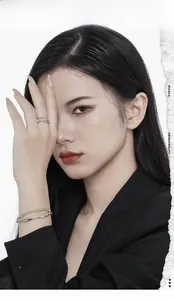 Detailed shot of silver bamboo-style texture ring and green bead bracelet on model