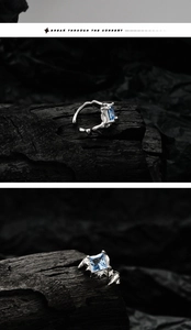 Detailed view of silver thorn texture ear cuff with square blue zircon on dark rock