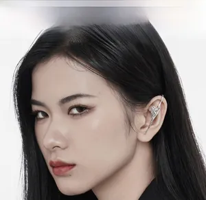 Close-up of sleek liquid metal silver ear cuff on model with a modern avant-garde style