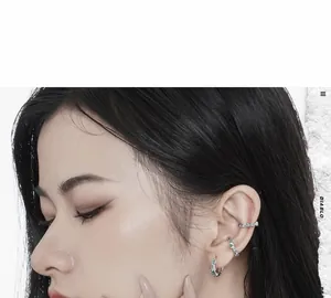 Detail of S925 silver ear cuff set with sea blue stones on a female model profile