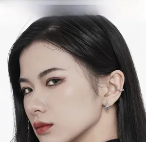 Close-up of S925 sterling silver coral blue enamel ear cuff and stud set on a model
