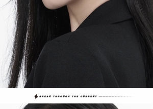 Detailed view of the black ribbed fabric texture and refined shoulder seam of the garment