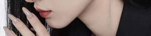 Close-up of minimalist S925 sterling silver long chain earrings on a model's ear