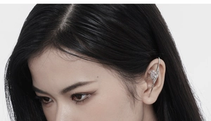 Close-up of liquid metal style silver ear cuff with avant-garde punk aesthetic