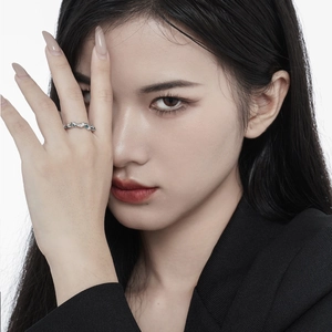 Irregular S925 sterling silver ring with blue enamel worn by a model in a black suit